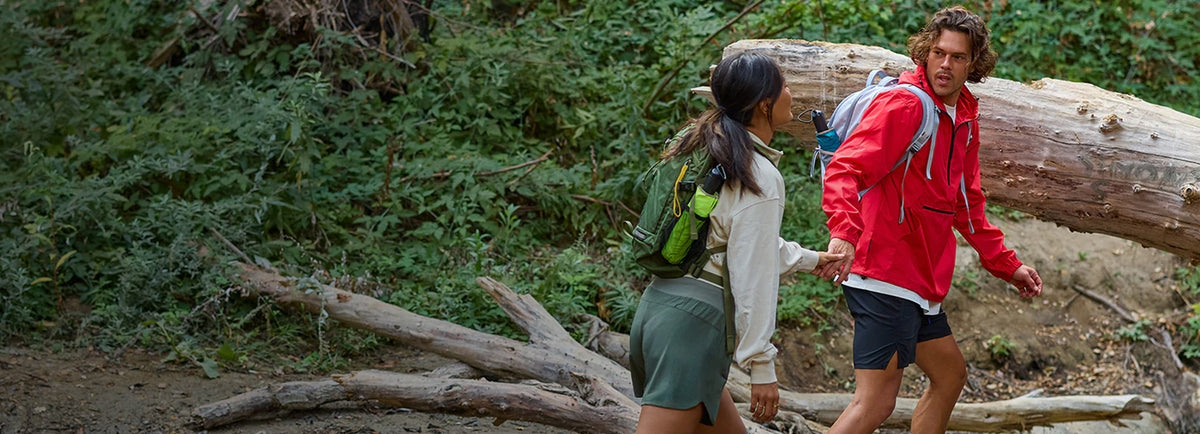 Man and woman hiking with backpacks in the forest