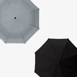 A gray and black umbrella, partially open 