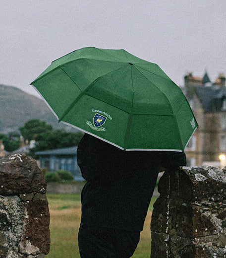 Man with a golf umbrella on a course 